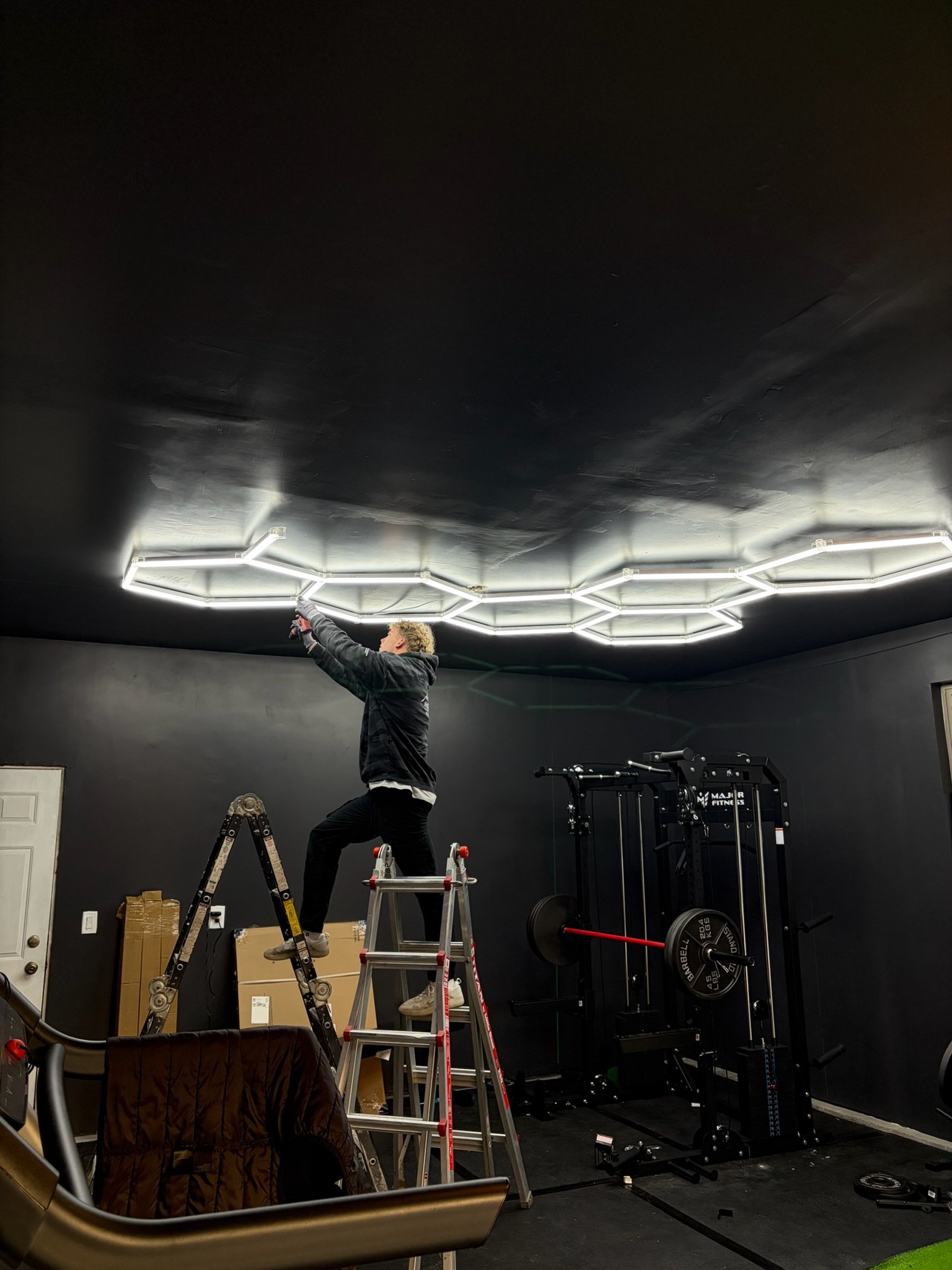 Big Hex Lighting crew installing a hex ceiling in a home gym