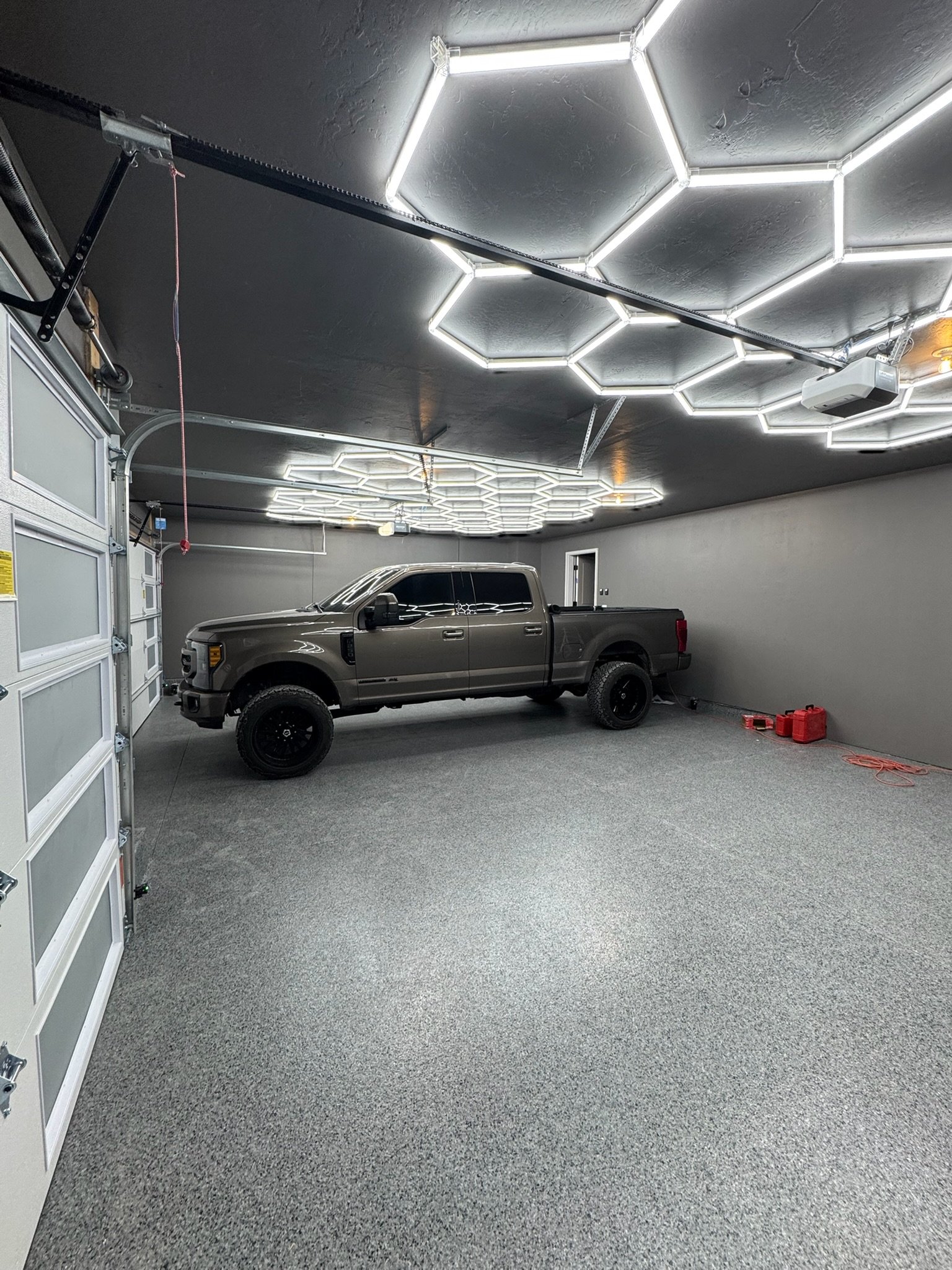 Lifted truck parked under a custom hex LED ceiling